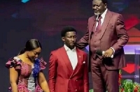 Cheddar and wife captured kneeling on the alter, Right (Bishop Charles Agyinasare)
