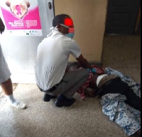 A patient at the Korle Bu hospital receives medical attention on the floor