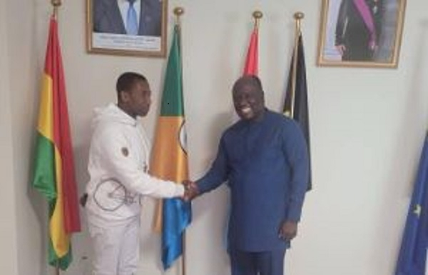 Kenpong in a handshake with Henry Tachie Menson