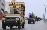 Libyan armored vehicles patrol after fighting between heavily armed militias in Tripoli, Libya