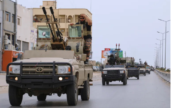 Libyan armored vehicles patrol after fighting between heavily armed militias in Tripoli, Libya