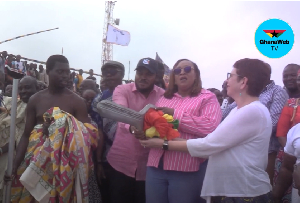 Minister of Fisheries and Aquaculture, Mavis Hawa Koomson in pink shirt holding the key