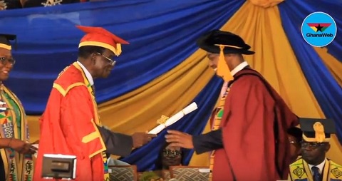 Prof. Emmanuel K. Akyeampong (L) receiving his certificate from the chairman of the school council