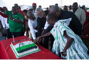 Rawlings with former President Mahama and some leadership of the party cutting the birthday cake.