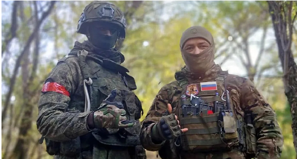 David Kuloba, seen with a Russian fighter, thought he had secured a well-paying job as a guard
