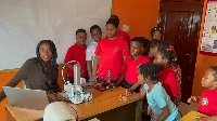 Gibrine (left) taking the students through the initiative