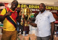 Representatives of Hearts and Kotoko holding the trophy