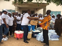 Rev. Bright Offei hands over the items to CSP William Anaman