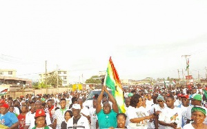 Julius Debrah with a flag during a health walk
