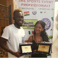 Daniel Kofi Agyei and his wife displaying with the awards.