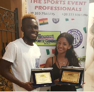 Daniel Kofi Agyei and his wife displaying with the awards.