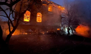 A firefighter works at the site of a residential building damaged during Russian missile