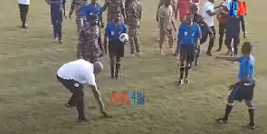 Coach Zerbo sweeping the pitch for referees