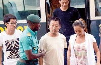 Aisha En Huang with her accomplices arriving at the court