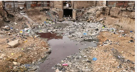 Photo of a gutter filled with filth
