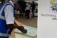 File: A presiding officer is seen securing the ballot after voting