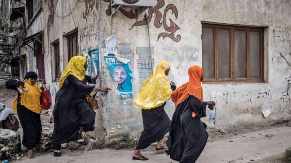 Women flee to find shelter when Zanzibar riot police set upon opposition protestors in Stone Town