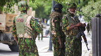 Kenyan police officers stand together during a joint operation with Haitian Police