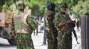 Kenyan police officers stand together during a joint operation with Haitian Police