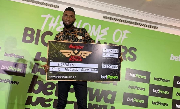 Fuseini poses with his dummy cheque