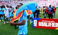 DR Congo's Cedric Bakambu celebrates qualifying for the FIFA World Cup by beating Jamaica