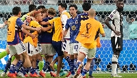 Japan celebrating their win as German defender Rudiger watches on