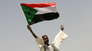 A man holds the Sudanese flag amid protests that ousted ex president Al-Bashir