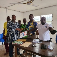 Ishmael Evonla Whajah (in smock) presenting his nomination forms to NPP officials in Jomoro
