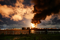 Smoke rises above the city following an air attack on the oil terminal in Saint Petersburg, Russia