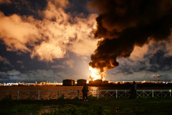 Smoke rises above the city following an air attack on the oil terminal in Saint Petersburg, Russia