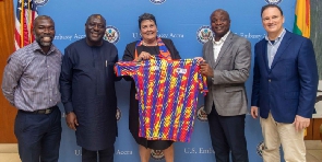 Togbe Afede (second right) presented the jersey the ambassador