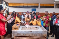 Dr Mustapha Abdul -Hamid cutting the cake with the pupils of Dzorwulu Special School in Accra