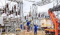 Technicians servicing a power substation
