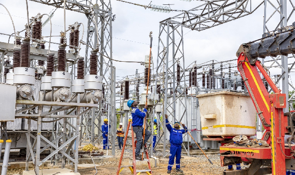 Technicians servicing a power substation