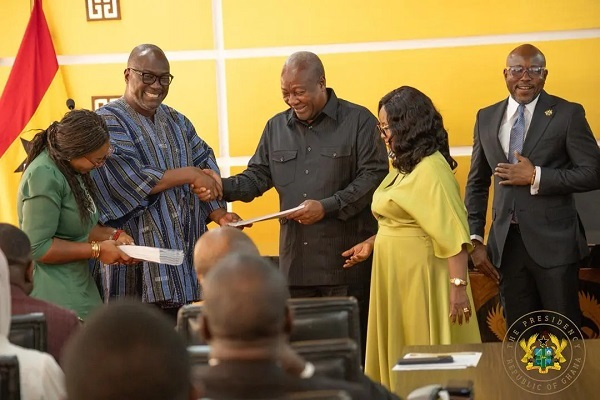 Members of the CRC presenting their report to President John Dramani Mahama