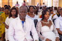 55-year-old Linda Ampofo and her husband seated in church