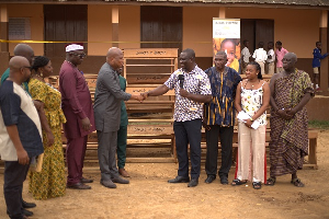 Samuel Okudzeto Ablakwa (L) shaking hands with a member of the organization