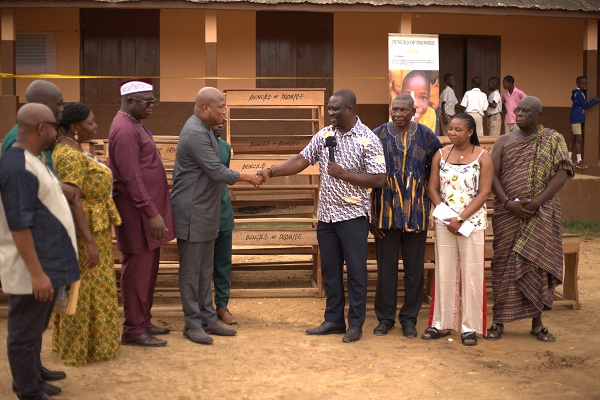 Samuel Okudzeto Ablakwa (L) shaking hands with a member of the organization