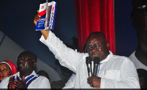 Nana Akufo-Addo holding the NPP manifesto in 2016