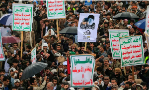 Supporters of Yemen's Houthi rebels hold a placard bearing a portrait of Iran’s slain Supreme Leader