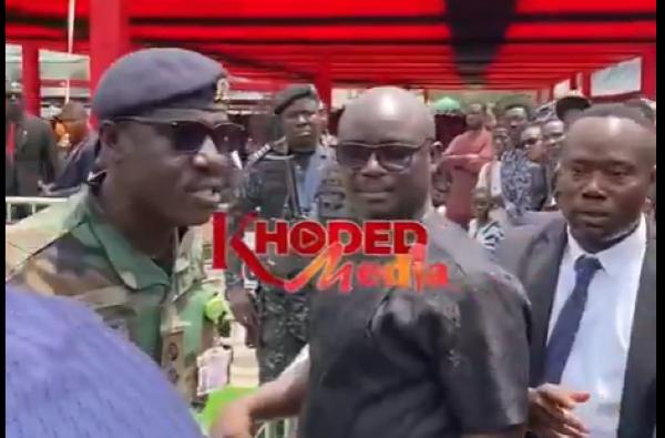 Watch as a soldier angrily disciplines a young man at a funeral