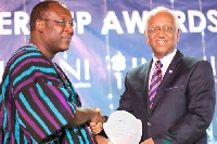 Mr Kofi Bentil (left), the Deputy Head of IMANI, Ghana, presenting a special award to Mr Girmay Hail