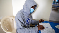 Patient studies while receiving treatment in a COVID-19 ward at Kenyatta Hospital