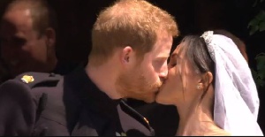 Prince Harry and Meghan share a kiss on the steps outside St George's Chapel