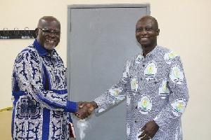 Hon. Hackman Owusu Agyemang, Board Chairman of COCOBOD in a hand-shake with Dr. Albert Benneh