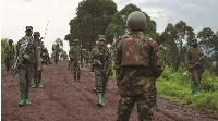 Congolese M23 rebels are seen as they withdraw from the 3 antennes location in Kibumba