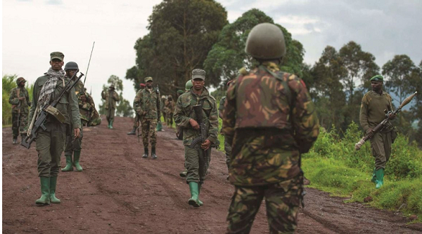 Congolese M23 rebels are seen as they withdraw from the 3 antennes location in Kibumba