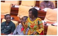 Della Adjoa Sowah displaying a ball of kenkey on the floor of parliament