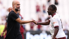 Manchester City manager, Pep Guardiola and Jeremy Doku