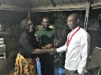 Albert Amekudzi, New President (R) being congratulated by Rotarian Past President Mercy (L)